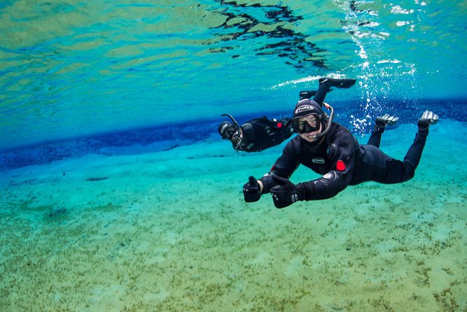 Silfra Fissure Snorkeling From Reykjavík - Free Underwater Photos - Getting into the dry suit takes patience